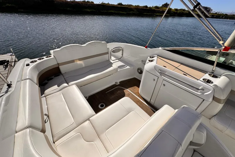 Slide: The Image of 2012 Formula 290 Sun Sport boat interior with white seating and water view. - 9