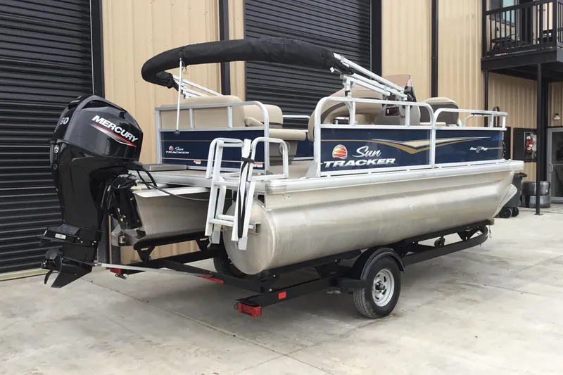 Slide: The Image of 2022 Sun Tracker Bass Buggy 16 XL pontoon boat with Mercury outboard motor on trailer. - 10