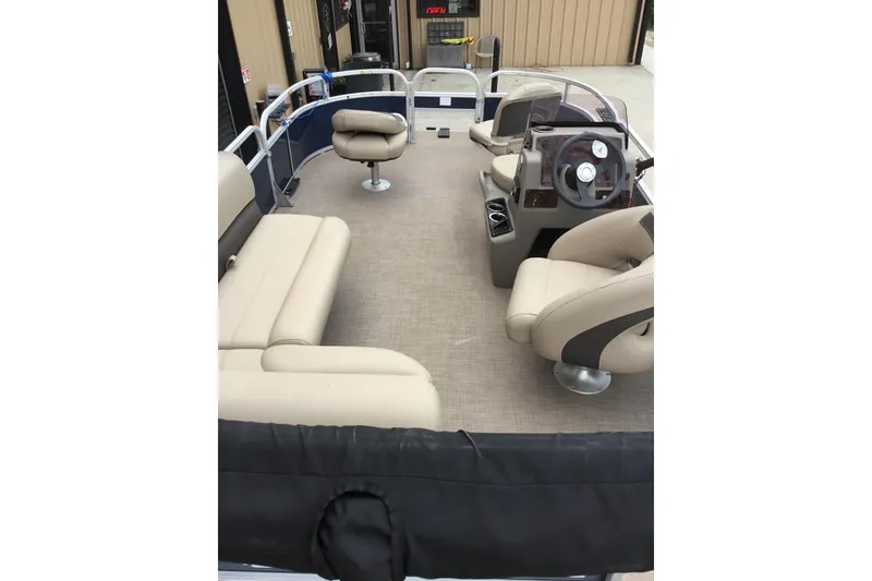 Slide: The Image of Interior view of 2022 Sun Tracker Bass Buggy 16 XL pontoon boat with beige seating. - 5