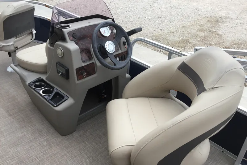 Slide: The Image of 2022 Sun Tracker Bass Buggy 16 XL boat interior with steering console and beige seating. - 7