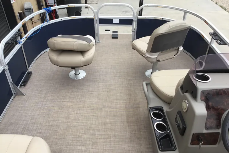 Slide: The Image of 2022 Sun Tracker Bass Buggy 16 XL pontoon boat interior with beige seating and console. - 8