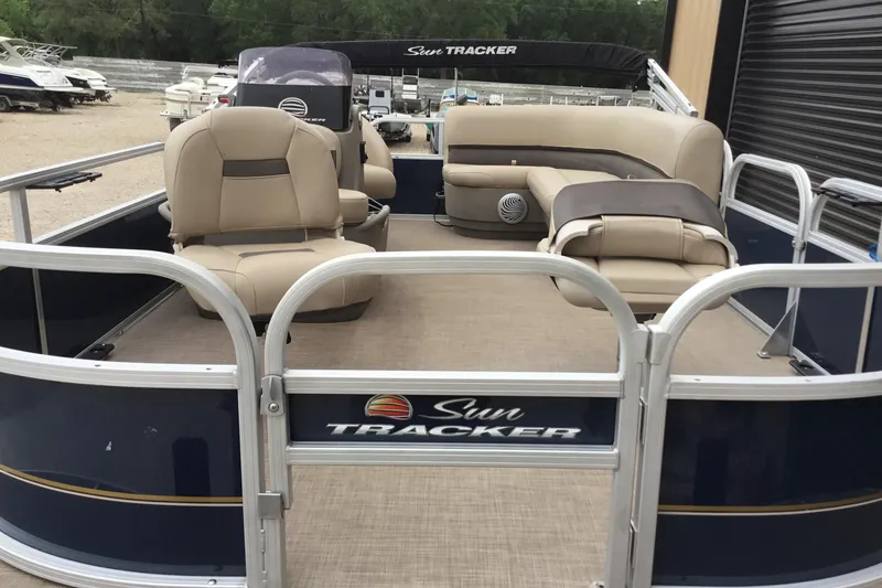 Slide: The Image of 2022 Sun Tracker Bass Buggy 16 XL pontoon boat with beige seating and open deck. - 9