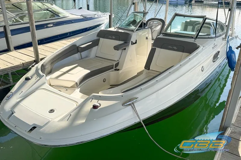 The Image of 2011 Sea Ray 260 Sundeck boat docked, featuring spacious seating and sleek design. - 0