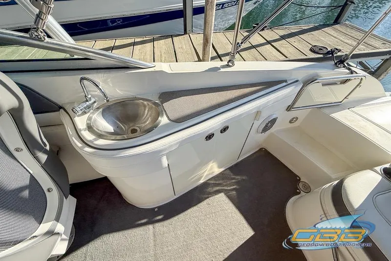 Slide: The Image of 2011 Sea Ray 260 Sundeck interior with sink and seating area. - 10