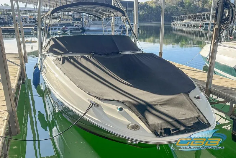 Slide: The Image of 2011 Sea Ray 260 Sundeck boat docked with black cover in marina. - 5