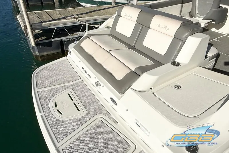 Slide: The Image of 2011 Sea Ray 260 Sundeck boat with cushioned seating at a dock. - 6