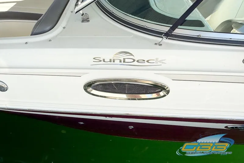Slide: The Image of 2011 Sea Ray 260 Sundeck boat side view with logo and window detail. - 7