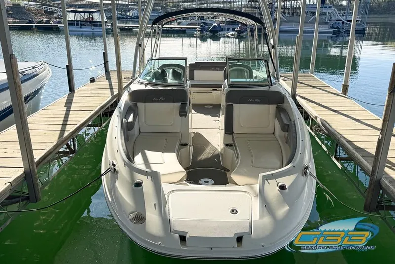 Slide: The Image of 2011 Sea Ray 260 Sundeck boat docked at marina with green water. - 9
