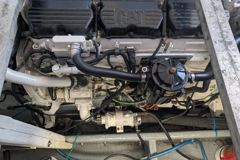 Slide: The Image of Engine of a 1995 MDI Down East boat, featuring CAT components and visible wiring. - 12