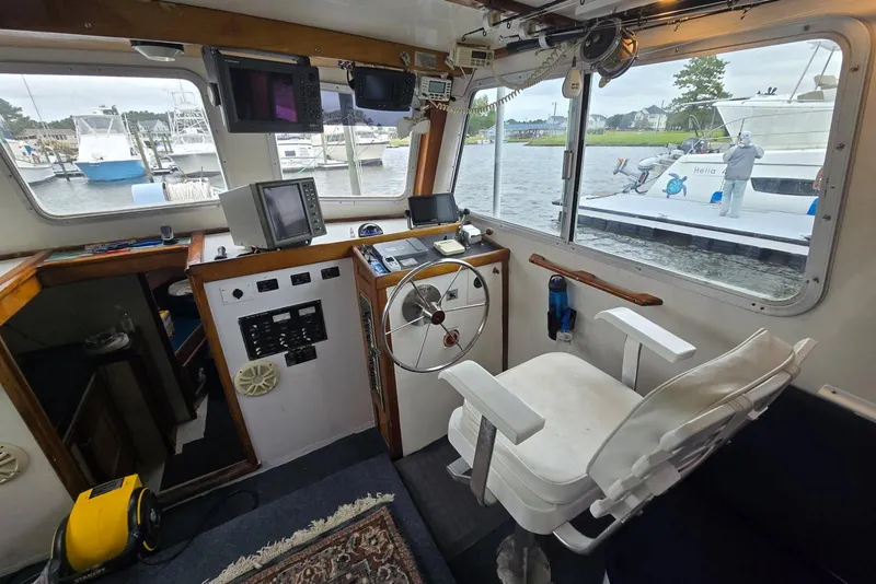 Slide: The Image of Interior of a 1995 MDI Down East boat with steering wheel and navigation equipment. - 8