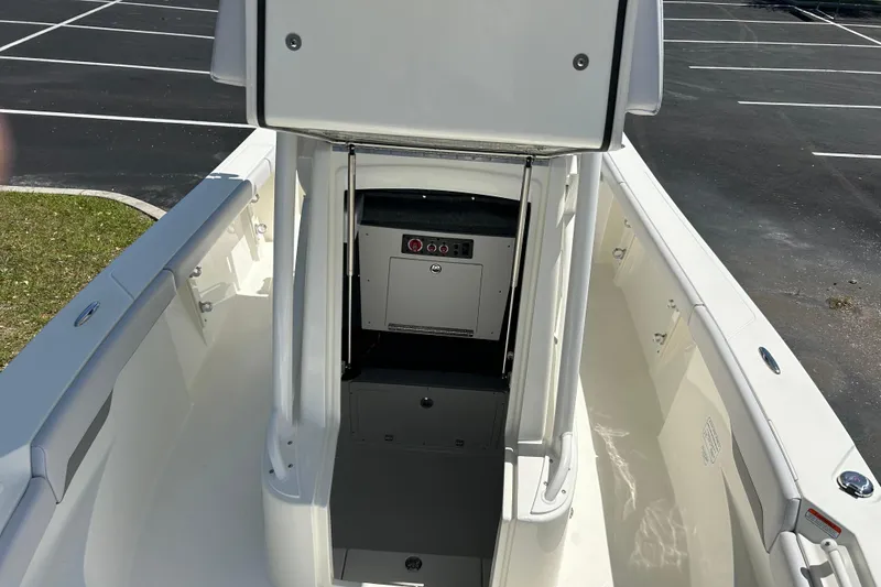 Slide: The Image of 2026 Mako 226 Center Console boat interior with storage compartment, parked on asphalt. - 5