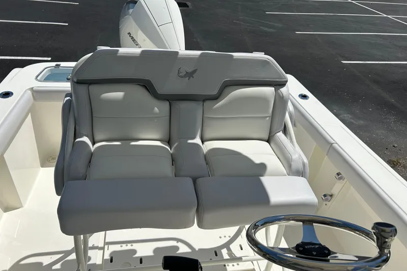 Slide: The Image of 2026 Mako 226 Center Console boat with plush seating and steering wheel. - 8