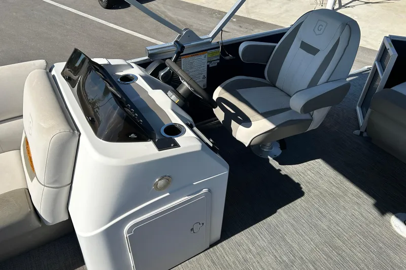 Slide: The Image of 2021 Godfrey Sweetwater 1880 CX boat interior with captain's chair and control console. - 10