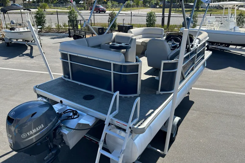 Slide: The Image of 2021 Godfrey Sweetwater 1880 CX pontoon boat with Yamaha motor, parked outdoors. - 7