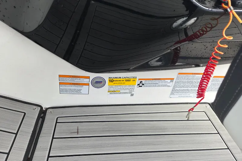 Slide: The Image of 2023 Yamaha Boats 222S capacity label, maximum 10 persons or 1860 lbs, safety warnings visible. - 10