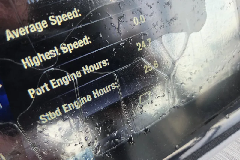 Slide: The Image of Dashboard of 2023 Yamaha Boats 222S showing speed and engine hours in rainy conditions. - 11