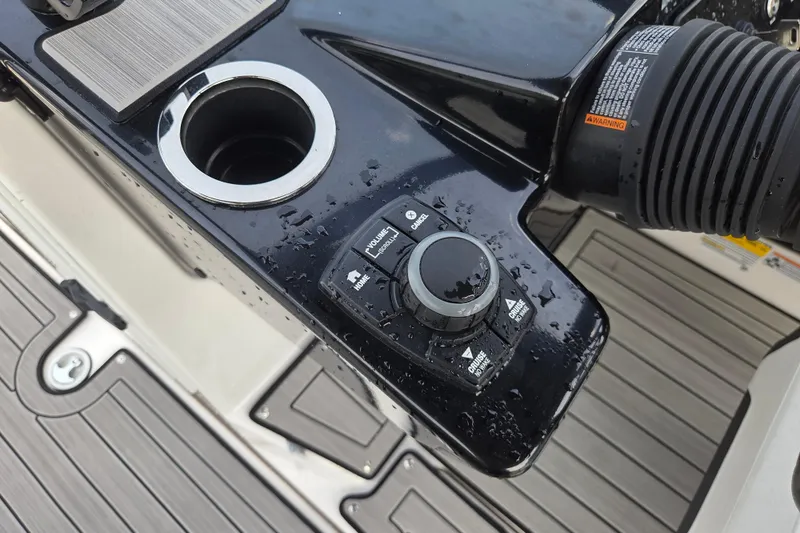 Slide: The Image of Control panel of 2023 Yamaha Boats 222S, featuring a sleek design with a cup holder. - 12