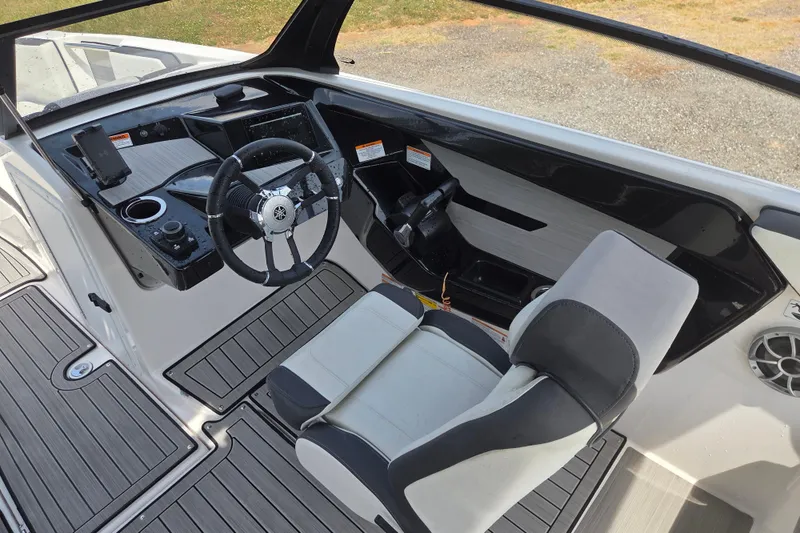 Slide: The Image of 2023 Yamaha Boats 222S cockpit with modern steering and seating design. - 13