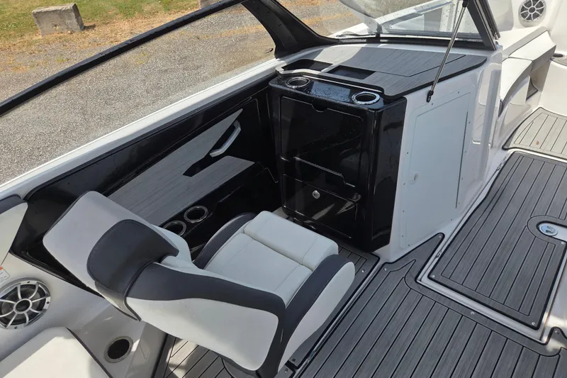 Slide: The Image of 2023 Yamaha Boats 222S interior with sleek seating and modern dashboard design. - 14