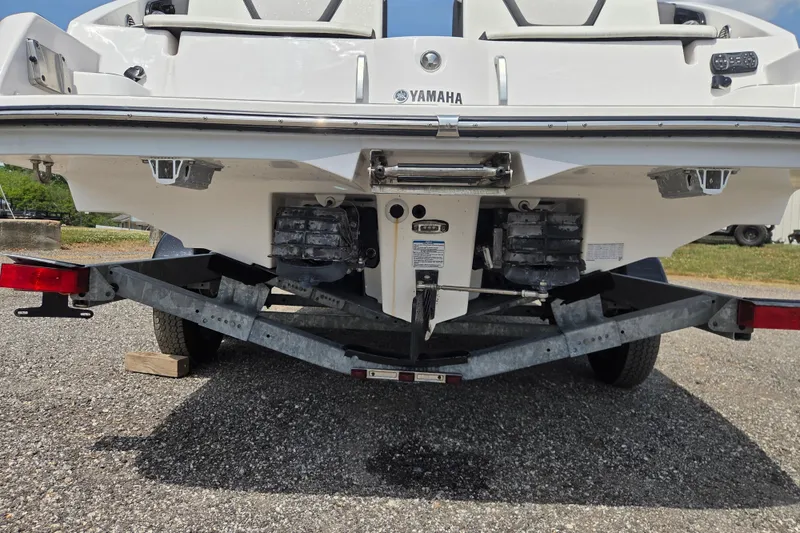 Slide: The Image of Rear view of 2023 Yamaha Boats 222S on a trailer, showcasing dual engines. - 6