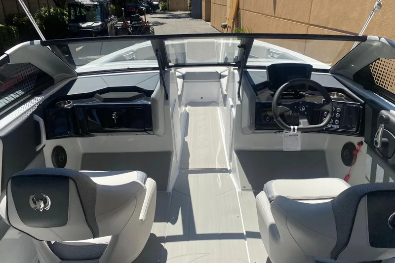 Slide: The Image of Interior view of 2025 Scarab 235 SE boat, featuring modern dashboard and seating. - 10