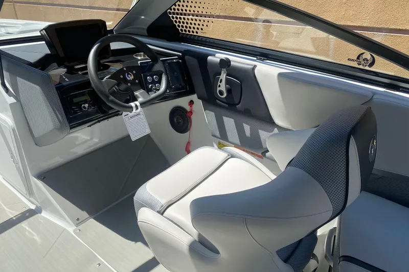 Slide: The Image of Interior of 2025 Scarab 235 SE boat, featuring modern steering and comfortable seating. - 12