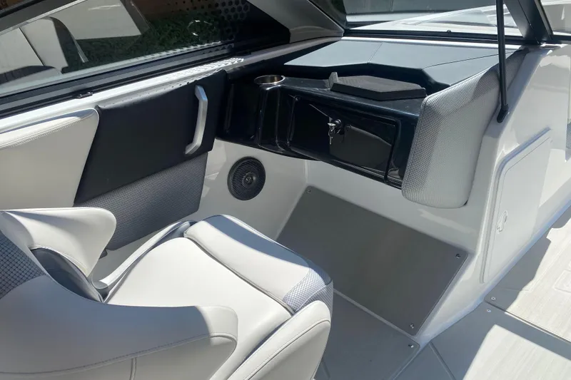 Slide: The Image of Interior of 2025 Scarab 235 SE boat, featuring sleek seating and modern dashboard design. - 14