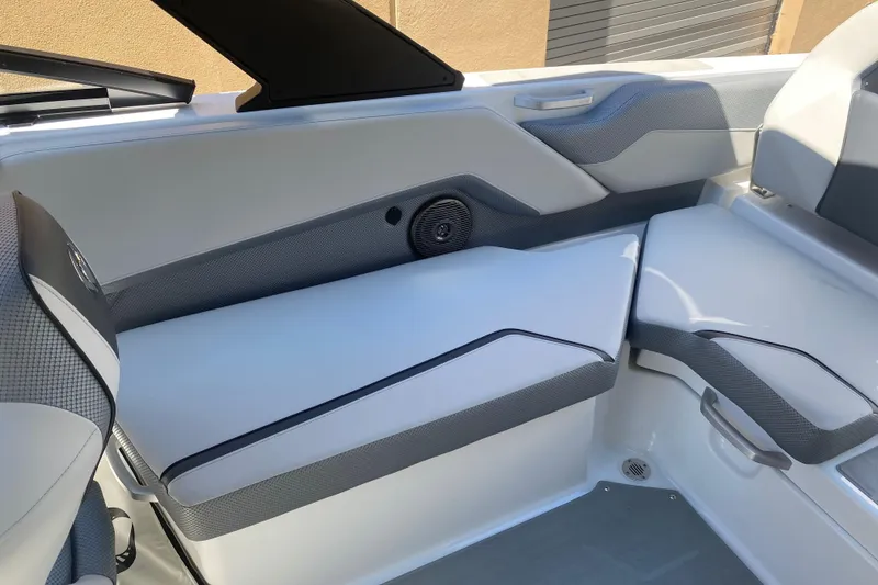 Slide: The Image of Interior seating of 2025 Scarab 235 SE boat, featuring modern design and speaker system. - 17