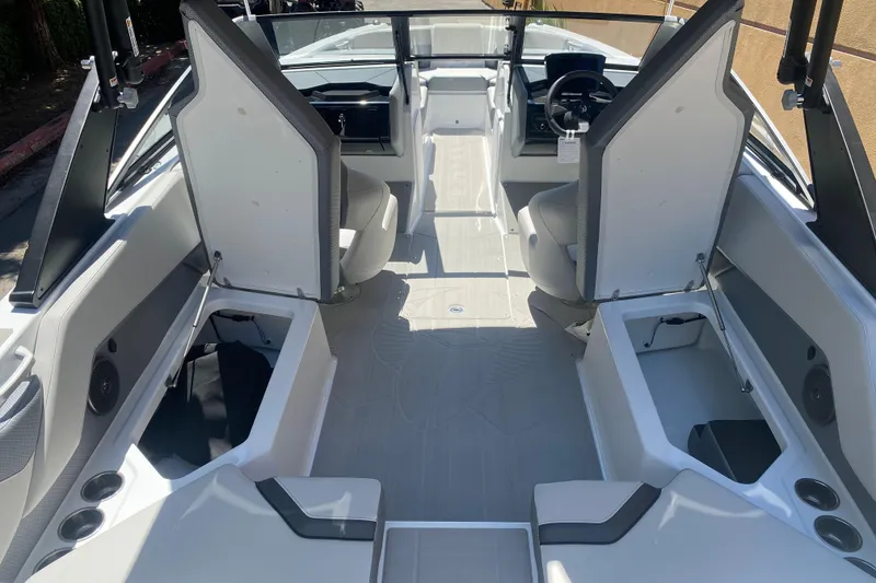 Slide: The Image of 2025 Scarab 235 SE boat interior with open storage compartments and modern seating. - 19