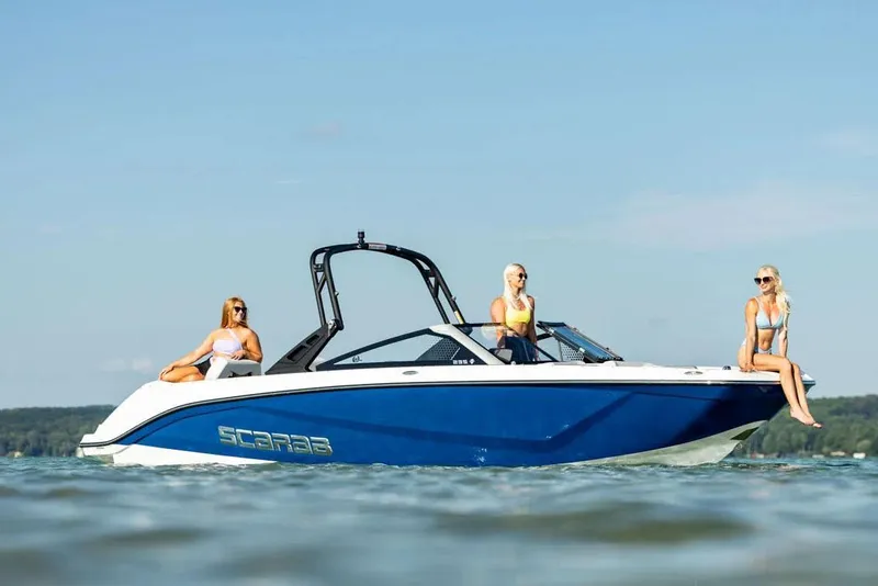 Slide: The Image of Manufacturer Provided Image: Scarab 235 SE 2025 on water with three people aboard. - 28