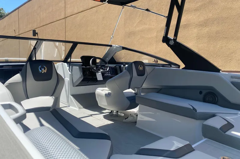 Slide: The Image of 2025 Scarab 235 SE boat interior with modern seating and sleek dashboard design. - 4