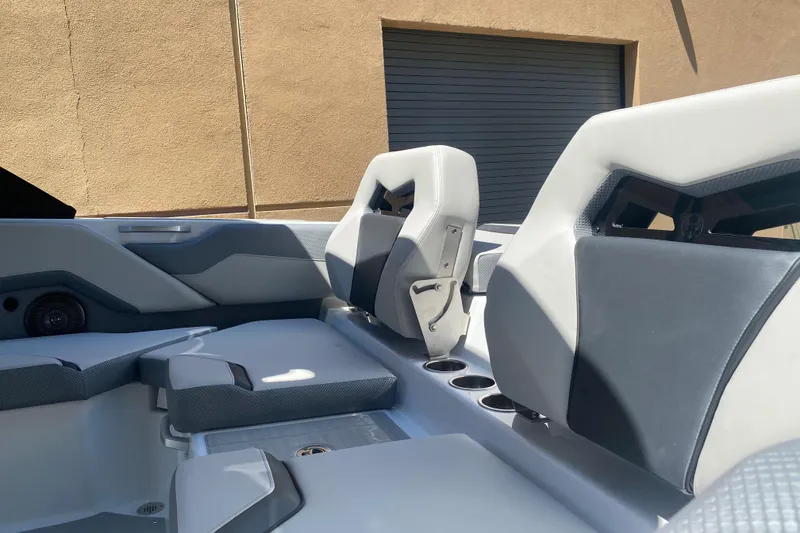 Slide: The Image of Interior of 2025 Scarab 235 SE boat, featuring modern seating and cup holders. - 5