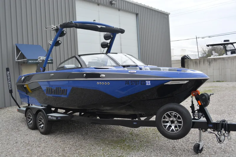 The Image of 2022 Malibu Wakesetter 23 LSV boat on trailer, parked outside a warehouse. - 0