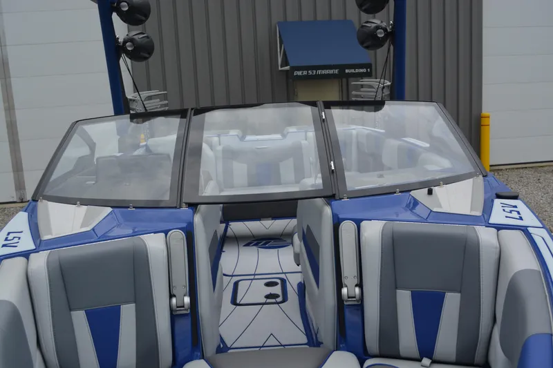 Slide: The Image of 2022 Malibu Wakesetter 23 LSV boat interior with blue and gray seating. - 10