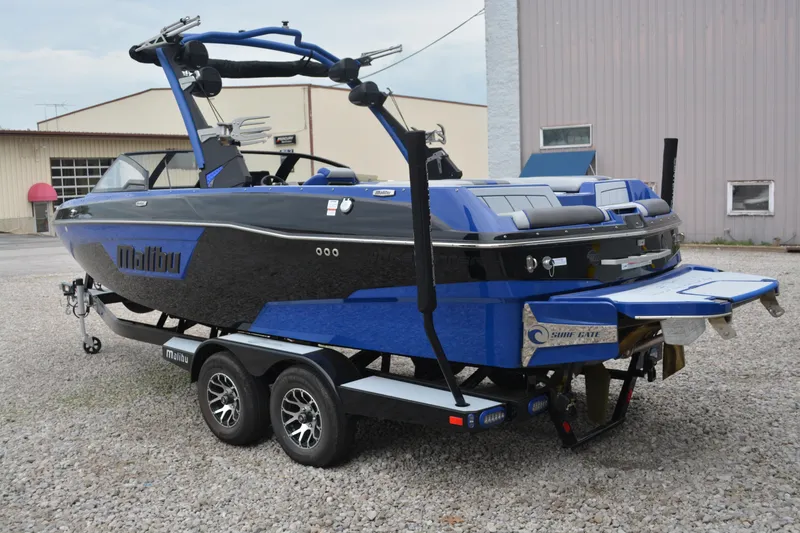 Slide: The Image of 2022 Malibu Wakesetter 23 LSV boat on trailer, featuring sleek black and blue design. - 3