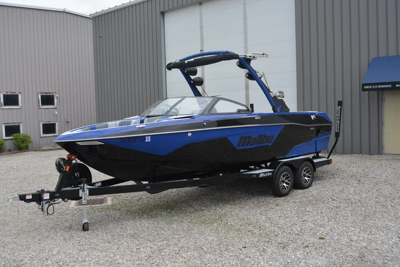 Slide: The Image of 2022 Malibu Wakesetter 23 LSV boat on trailer, parked outside a warehouse. - 6