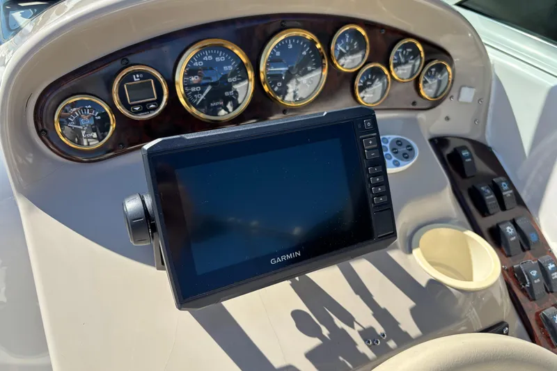 Slide: The Image of 2002 Rinker Fiesta Vee 270 dashboard with Garmin GPS and analog gauges. - 11