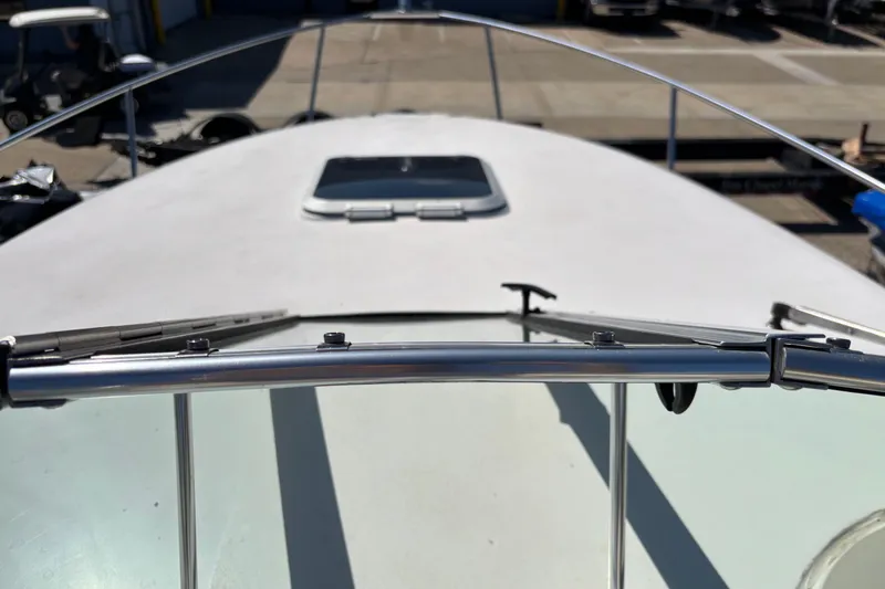 Slide: The Image of 2002 Rinker Fiesta Vee 270 boat deck with railing and hatch, docked in marina. - 12