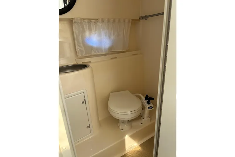 Slide: The Image of 2002 Rinker Fiesta Vee 270 boat bathroom with toilet and sink. - 16