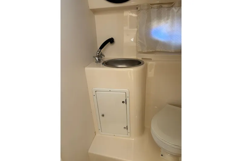 Slide: The Image of 2002 Rinker Fiesta Vee 270 bathroom with sink, faucet, and toilet. - 17