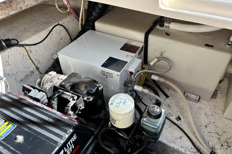 Slide: The Image of Engine compartment of 2002 Rinker Fiesta Vee 270 boat, showing mechanical components and wiring. - 20