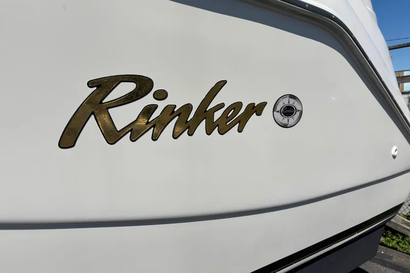 Slide: The Image of 2002 Rinker Fiesta Vee 270 boat logo on white hull. - 3
