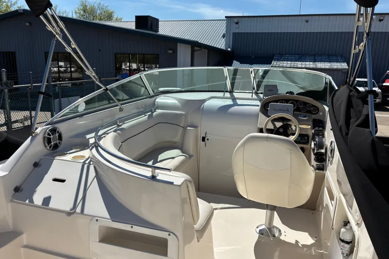 Slide: The Image of 2002 Rinker Fiesta Vee 270 boat interior with steering wheel and seating area. - 6