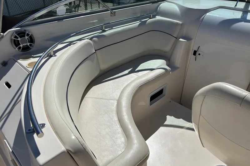 Slide: The Image of 2002 Rinker Fiesta Vee 270 boat interior with white seating and speaker. - 8