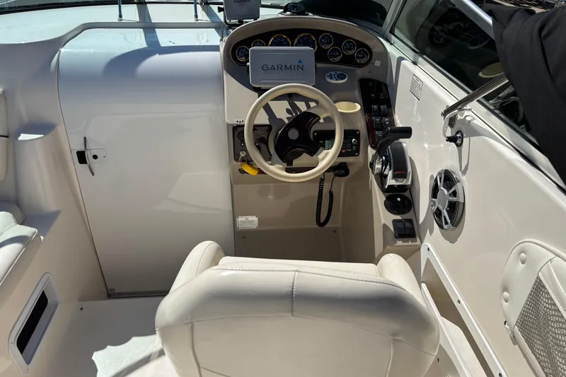 Slide: The Image of Cockpit of 2002 Rinker Fiesta Vee 270 with Garmin navigation system and steering wheel. - 9
