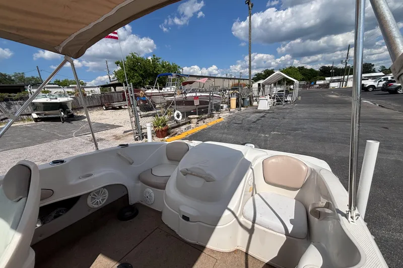Slide: The Image of 2002 Sea Ray 176 Bow Rider interior view at a marina under a sunny sky. - 12