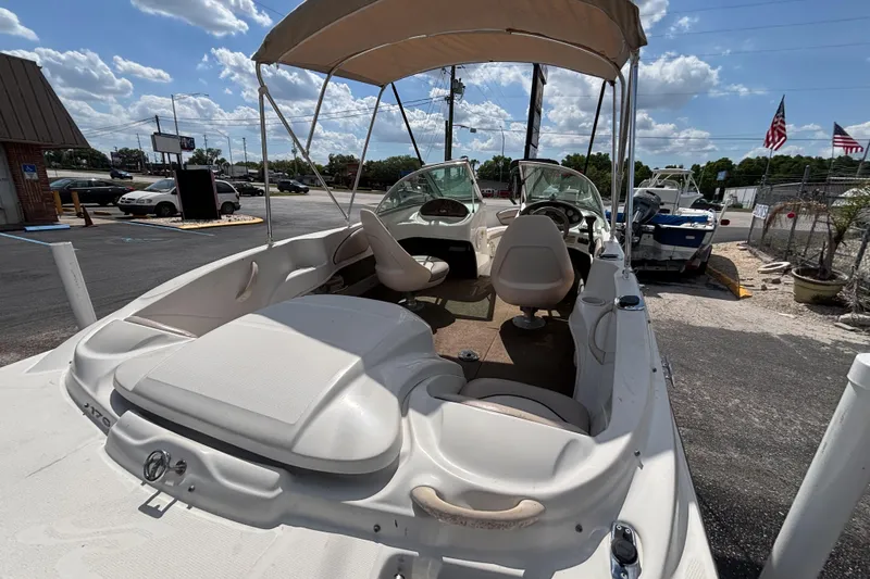 Slide: The Image of 2002 Sea Ray 176 Bow Rider boat with canopy, parked outdoors under a blue sky. - 16