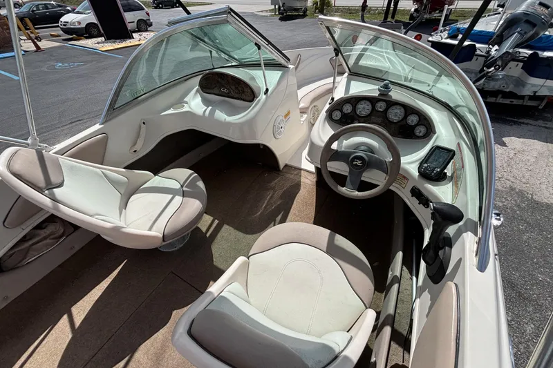 Slide: The Image of 2002 Sea Ray 176 Bow Rider interior with steering wheel and seating. - 17