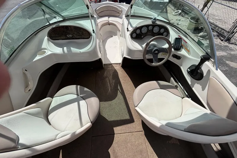 Slide: The Image of 2002 Sea Ray 176 Bow Rider interior with dual seating and steering console. - 19