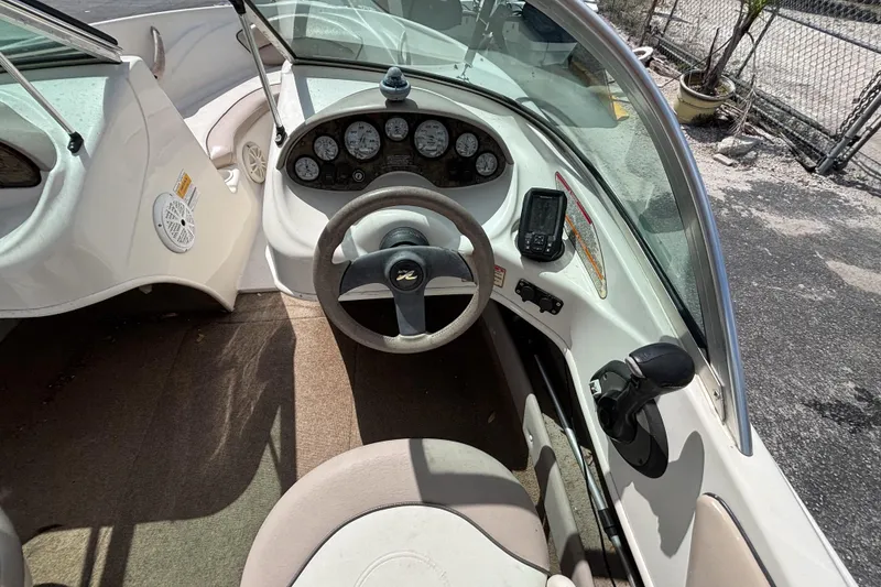 Slide: The Image of 2002 Sea Ray 176 Bow Rider cockpit with steering wheel, gauges, and navigation equipment. - 20